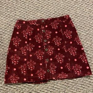 Velvety deep red print button skirt. Says size 7.